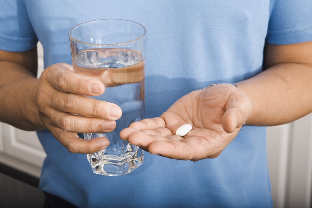 a man drinks a pill against parasites